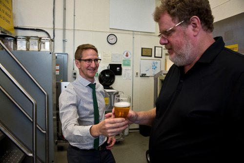 MIKE DEAL / WINNIPEG FREE PRESS
Peter Watts, Managing Director at the Canadian Malting Barley Technical Centre hands columnist Doug Speirs a very fresh glass of beer in their brewery on the main floor of the Canadian Grain Commission Building, 303 Main Street.
160922 - Thursday, September 22, 2016 - 

