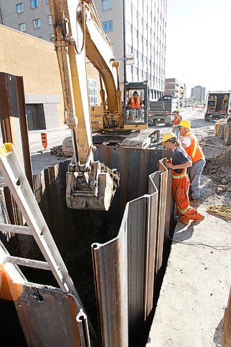 BORIS MINKEVICH / WINNIPEG FREE PRESS  080522 Construction crews work on Ellice near Smith. This was a scheduled project  to install special junction boxes for hydro, telephone, and other cables. A FORMAN ON SITE CONFIRMED THAT THIS WAS NOT A SINK HOLE.