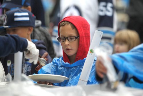 RUTH BONNEVILLE / WINNIPEG FREE PRESS

Jets fans young and old brave brisk, wet weather for a free pancake breakfast outside IcePlex Saturday for  Jets FanFest.  

September 24, 2016
