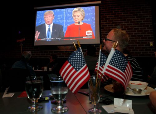 BORIS MINKEVICH / WINNIPEG FREE PRESS
LOCAL STDUP - Confusion Corner Bar & Grill, 500 Corydon Ave. aired the US presidential debate to a full house. Patrons watch the debate on the big screen. This man behind the American flags agreed to have his photo taken but didn't want his name used. Sept. 26, 2016