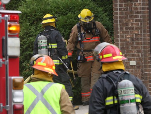 JOE BRYKSA / WINNIPEG FREE PRESS Firefighters emerge from a home in the 100 block of Smugglers Cove in Island Lakes Tuesday morning. Reports that there was a fire in the basement with no one injured.  Sept 27, 2016 -(Breaking News)