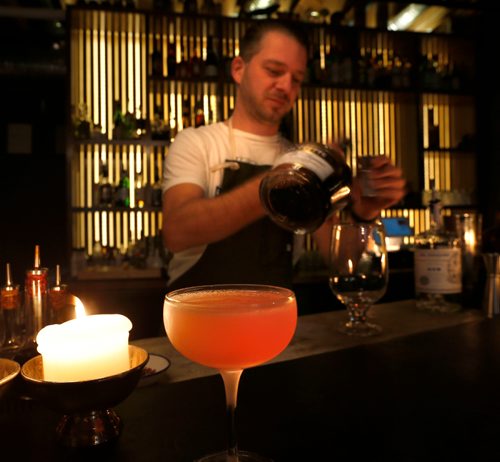 WAYNE GLOWACKI / WINNIPEG FREE PRESS


 Restaurant Review of the Forth at 171 McDermot Ave. Bartender Josey Krahn with an  Aviation cocktail in foreground prepared in the Forth bar.  Alison Gillmor story Sept. 27 2016