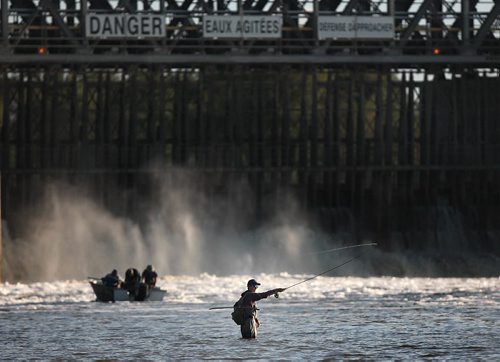 PHIL HOSSACK / WINNIPEG FREE PRESS - FISHERS - A fly fisher and a boatload of anglers on the Red River near the Lockport Damtrol and cast for their evening catch.   September 20, 2016