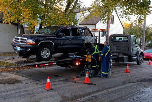 BORIS MINKEVICH / WINNIPEG FREE PRESS
BREAKING NEWS - Burned out SUV that is being towed away on Allan Street between William Newton Ave. and Talbot Ave. One of many fires in the area overnight.  Sept. 28, 2016