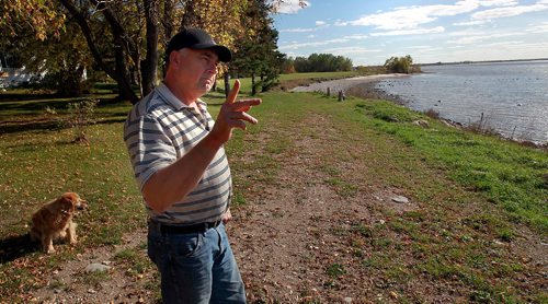 PHIL HOSSACK / WINNIPEG FREE PRESS -  Dave Craigie holds up a handfull of Zebra Mussels scooped up of his waterfront near Beaconia. See Kevin Rollason's story.  September 28, 2016