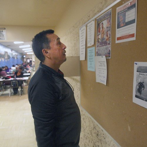 JOE BRYKSA / WINNIPEG FREE PRESS 

Father George Wood takes a momment to stare at a  missing person poster in the Freight House- 505 Ross Ave of their daughter 21 year old Christine Wood from Oxford House First Nation that went missing Oct 19 while visiting Winnipeg. Her parents have been searching Winnipeg since, hoping for a sighting.  They have been searching each night driving through many neighborhoods in Winnipeg. Sept 29, 2016 -(See Melissa Martin story)