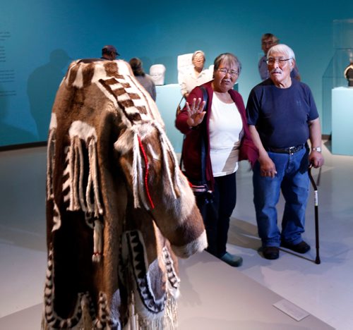 WAYNE GLOWACKI / WINNIPEG FREE PRESS

Peter and Elizabeth Awa visiting from the community of Iglulik look at a coat on display that is is a replica of coat worn by Peter's grandfather's who was a Shaman. They were attending the media viewing of Winnipeg Art Gallery's Inuit art exhibit from the Government of Nunavut's Fine Art Collections called OUR LAND:Contemporary Art From The Arctic. The exhibition consists of nearly 100 artworks and opens to the public with free admission on Friday night (Sept.30), the show runs until the new year. Sept. 30 2016