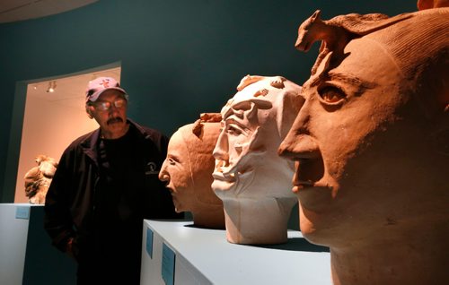 WAYNE GLOWACKI / WINNIPEG FREE PRESS

Visiting Master Artist Paul Quviq Malliki from Naujaat,  Nunavut,  by (from right) two ceramic sculptures by Robert Tatty, Rankin Inlet and a ceramic Woman's Head by an unidentified artist also from Rankin Inlet.  ( Paul does not have his artwork in this show).  This is part of the Winnipeg Art Gallery's Inuit art exhibit from the Government of Nunavut's Fine Art Collections called OUR LAND:Contemporary Art From The Arctic. The exhibition consists of nearly 100 artworks and opens to the public with free admission on Friday night (Sept.30), the show runs until the new year. Sept. 30 2016