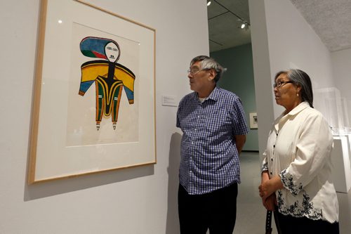 WAYNE GLOWACKI / WINNIPEG FREE PRESS

William and Martha Noah with a lithograph tiltled WOMAN  by William's mother Jessie Oonark who lived in Baker Lake . They were attending the media viewing of Winnipeg Art Gallery's Inuit art exhibit from the Government of Nunavut's Fine Art Collections called OUR LAND:Contemporary Art From The Arctic. The exhibition consists of nearly 100 artworks and opens to the public with free admission on Friday night (Sept.30), the show runs until the new year. Sept. 30 2016