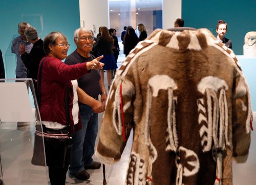 WAYNE GLOWACKI / WINNIPEG FREE PRESS

Peter and Elizabeth Awa visiting from the community of Iglulik look at a coat on display that is a replica of coat worn by Peter's grandfather's who was a Shaman. They were attending the media viewing of Winnipeg Art Gallery's Inuit art exhibit from the Government of Nunavut's Fine Art Collections called OUR LAND:Contemporary Art From The Arctic. The exhibition consists of nearly 100 artworks and opens to the public with free admission on Friday night (Sept.30), the show runs until the new year. Sept. 30 2016