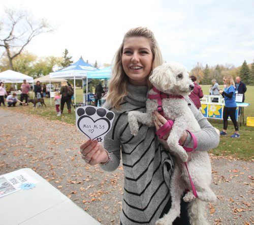 RUTH BONNEVILLE / WINNIPEG FREE PRESS

Mallory Vandenberg holds her three-year-old Bichon Poodle named "Sophie"  places a paw print on a board in memory of one of her dogs as part of a fundraiser at  CancerCare's Bark for Life at St. Vital Park Saturday.  

October 1st, 2016
