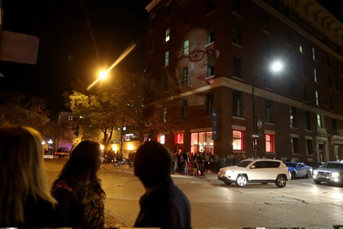 TREVOR HAGAN / WINNIPEG FREE PRESSPhotographer Leif Norman projects potraits onto the side of the Crocus Building, as part of Nuit Blanche, Saturday, October 1, 2016.