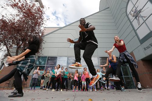 JOHN WOODS / WINNIPEG FREE PRESS
Eugene Baffoe, instructor at the Royal Winnipeg Ballet, leads a group of dancers outside the Royal Winnipeg Ballet (RWB) as part of Dance Downtown, Sunday, October 2, 2016. RWB, Dance Manitoba and Rainbow Stage invited people to take part in 2016 MB Dance Day as part of the national Cultural Days 2016, a cross-country volunteer initiative to help raise awareness, participation and engagement in arts and cultural activities and events in our communities.

