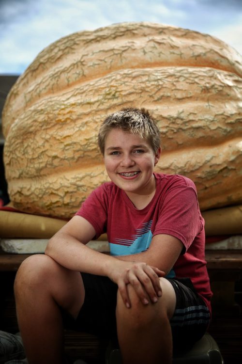 MIKE DEAL / WINNIPEG FREE PRESS

Milan Luke's, 14, with his winning pumpkin from this weekends Rolland Pumpkin Festival. His second win in a row and his fourth year entering. Though the scale was damaged earlier in the competition he had his pumpkin weighed unofficially at a local grain elevator at around 1352 lbs. 

161002
Sunday, October 02, 2016