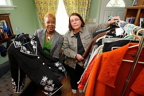 BORIS MINKEVICH / WINNIPEG FREE PRESS  080525 Free Press employee Debbie Thompson, right, goes through some clothing with wardrobe consultant Angela Shurland, left, in her home in St. Boniface. To go with clothing makeover story.