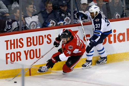 JOHN WOODS / WINNIPEG FREE PRESS
Winnipeg Jets' Dustin Byfuglien (33) chases Ottawa Senators' Mark Borowiecki (74) into the corner during first period pre-season NHL action in Winnipeg on Monday, October 3, 2016.