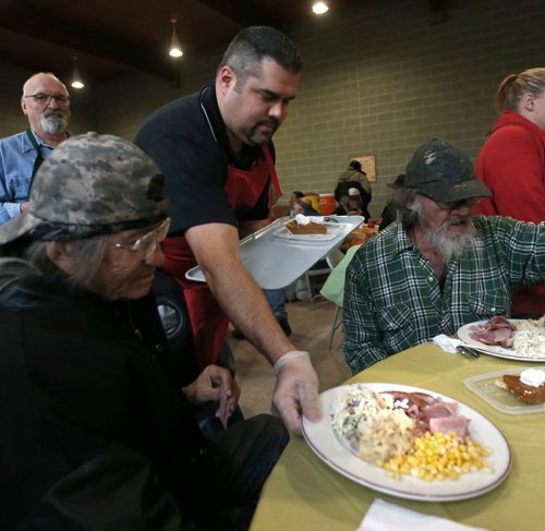 WAYNE GLOWACKI / WINNIPEG FREE PRESS
Volunteer Chris Preston serves Dave Bush at the annual Thanksgiving Feast at the Agape Table Friday morning. About 400 guests are expected to attend for the ham dinner meal, the lineup started an hour before the doors opened. Oct. 7 2016
