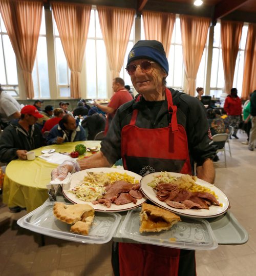 WAYNE GLOWACKI / WINNIPEG FREE PRESS
Volunteer Guy Madill with the Kinsmen Club of Winnipeg prepares to serve guests attending the annual Thanksgiving Feast at the Agape Table Friday morning. About 400 are expected to attend for the ham dinner meal, the lineup started an hour before the doors opened. Oct. 7 2016