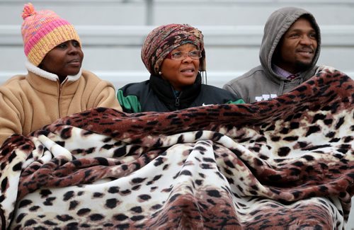 TREVOR HAGAN / WINNIPEG FREE PRESS
Adama Iashid, Hawa Gassama, and Nfaba Gassama stay huddled under a blanket while supporting Vincent Massey Trojans, Abdul Gassama during his game against the Grant Park Pirates, Friday, October 7, 2016.