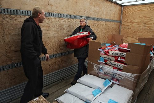 MIKE DEAL / WINNIPEG FREE PRESS

Joanne Rex a volunteer with FortWhyte Alive gets Art Hart a bag of bird seed during the weekend long Truckload Bird Seed and Honey sale Sunday morning. 

161009
Sunday, October 09, 2016