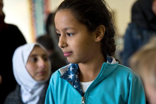 MIKE DEAL / WINNIPEG FREE PRESS
Aya, 10, translates for her parents during an interview at a potluck supper hosted by Refuge Winnipeg for the three Syrian refugee families who arrived here last October and all the people who privately sponsored them Monday afternoon at the First Unitarian Universalist Church of Winnipeg.
161010 - Monday, October 10, 2016 - 

