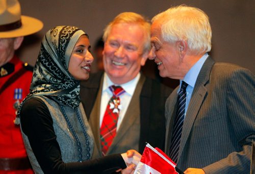 BORIS MINKEVICH / WINNIPEG FREE PRESS
In celebration of Citizenship Week (October 10-16),  the Honourable John McCallum, right, Minister of Immigration, Refugees and Citizenship, attended a special citizenship ceremony at the Canadian Museum of Human Rights in Winnipeg. Here he welcomes new Canadian citizen Nadia Kidwai, left, while Dwight MacAulay, middle, Chief of Protocol for the Government of Manitoba looks on. They were joined by Provincial-Territorial Ministers responsible for Immigration to welcome 20 new citizens. Oct. 11, 2016