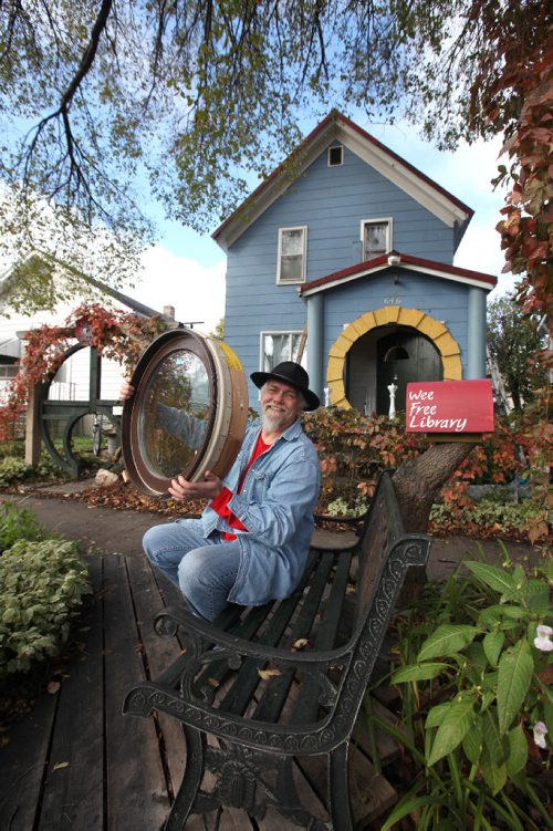RUTH BONNEVILLE / WINNIPEG FREE PRESS

49.8 Intersection Feature:
Victor Street Home owner, Hardy Groening, shows off his so-called Hobbit House.  His two-story  home is something to behold with its big round door,  round gate and window that he is about to install.  His home also features a indoor climbing wall (he has climbing ropes for safety, not in photo) and hobbit sized doorway off one of the upstairs bedrooms leading to a second-storey deck that looks like a boat.  
See Dave Sanderson story.  
October 08, 2016

