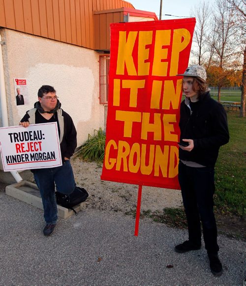 BORIS MINKEVICH / WINNIPEG FREE PRESS
Natural Resource Minister Jim Carr holds a town hall at Fort Garry Community Centre in Winnipeg. In this photo Mike Bagamery, left, and Mitchell Van Ineveld, right, wait for Carr outside the venue with signs before it started Thursday evening. Oct. 13, 2016