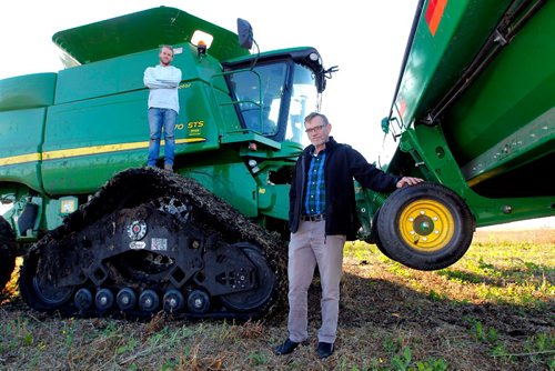 BORIS MINKEVICH / WINNIPEG FREE PRESS
University of Winnipeg Mennonite history prof Royden Loewen and part time farmer researches the connection between faith and farming in seven international communities. In this photo Royden Loewen,right, and son Sasha Loewen, left-standing on combine tracks, pose for a photo during a break from harvesting soybeans this afternoon in the Steinbach area. Oct. 13, 2016