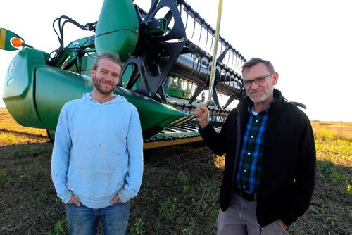 BORIS MINKEVICH / WINNIPEG FREE PRESS
University of Winnipeg Mennonite history prof Royden Loewen and part time farmer researches the connection between faith and farming in seven international communities. In this photo Royden Loewen,right, and son Sasha Loewen, left, pose for a photo during a break from harvesting soybeans this afternoon in the Steinbach area. Oct. 13, 2016