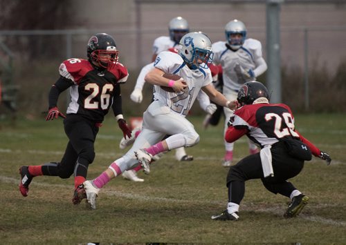 DAVID LIPNOWSKI / WINNIPEG FREE PRESS

Oak Park Raiders Zachary Wood (#21) runs the ball at Charlie Krupp Stadium while playing the Sisler Spartans Friday October 14, 2016, less than a week after their equipment storage unit went up in flames.
