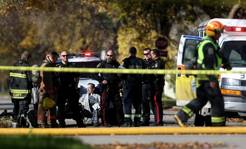 TREVOR HAGAN / WINNIPEG FREE PRESS
Police and fire fighters at the scene at Church Avenue and Minnigaffe Street, Saturday, October 15, 2016.