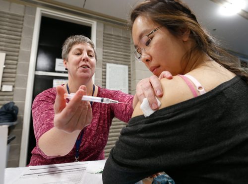 WAYNE GLOWACKI / WINNIPEG FREE PRESS

Occupational Health Nurse Jennifer Field gives the flu vaccine to Resident Doctor Jessica Chan during the 20th annual Bug Day held Tuesday in the University of Manitoba Basic Medical Sciences Building. Bug Day is Manitobas largest healthcare education event, and is hosted by the Health Sciences Centre Winnipeg in collaboration with the University of Manitobas Continuing Professional Development  Medicine Group.  Experts from the University of Manitoba, Winnipeg Regional Health Authority, Manitoba Health, National Microbiology Laboratory, Public Health Agency of Canada and the  University of Alberta gave presentations for the prevention and control of communicable diseases, as well as health issues in the community or healthcare setting. Bug Day is held every
year during National Infection Prevention & Control Week.  see city desk news release  Oct. 18 2016