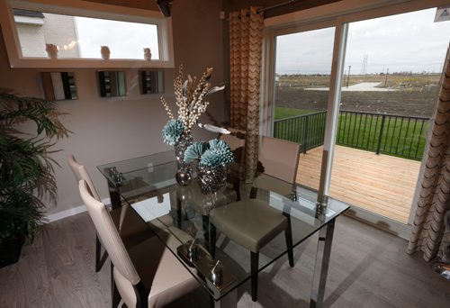 WAYNE GLOWACKI / WINNIPEG FREE PRESS

Homes. The table by the kitchen with a sliding door to the back yard deck in3 Snowberry Circle in Sage Creek.   The Kensington Homes sales rep is  Rene Giroux. Todd Lewys story   Oct. 18 2016