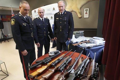 JOE BRYKSA / WINNIPEG FREE PRESSThree police services from Manitoba displayed seized items from project Derringer in Brandon, Manitoba Oct 12-15, 2016- Items seized included firearms, cash , vehicles , and drugs- L to R Inspector Max Waddell, Supervisor, Organized Crime Unit, Winnipeg Police Service, Deputy Chief Randy Lewis, Operations, Inspector Tim Olmstead, Officer in Charge, Federal Serious and Organized Crime, RCMPBrandon Police Service look over seized goods  at RCMP D Division headquarters in Winnipeg -Oct 19, 2016 -(See Carol Sanders story)
