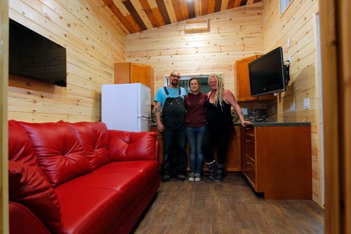 BORIS MINKEVICH / WINNIPEG FREE PRESS
Anita Munn, right,  and her husband, Darrell Manuliak, left, and daughter Bridget Stewart, middle, pose for a photo in one of their mini homes. This one is going to be delivered this Friday to a client who lives near Clear Lake, Manitoba. For story on how the company cant get the city to change its bylaws to allow for mini homes to be build on lots in Winnipeg. Photographed at Mini Homes of Manitoba, Inc. at Unit 13-1557 Brookside Blvd. Oct. 19, 2016
