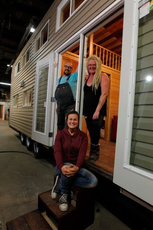 BORIS MINKEVICH / WINNIPEG FREE PRESS
Anita Munn, top right, and her husband, Darrell Manuliak, top left, and daughter Bridget Stewart, bottom middle, pose for a photo in one of their mini homes. This one is going to be delivered this Friday to a client who lives near Clear Lake, Manitoba. For story on how the company cant get the city to change its bylaws to allow for mini homes to be build on lots in Winnipeg. Photographed at Mini Homes of Manitoba, Inc. at Unit 13-1557 Brookside Blvd. Oct. 19, 2016