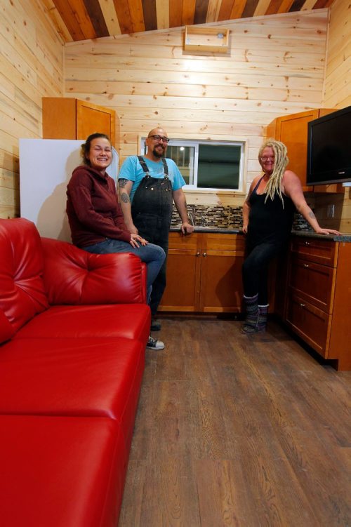 BORIS MINKEVICH / WINNIPEG FREE PRESS
Anita Munn, right, and her husband, Darrell Manuliak, middle,  and daughter Bridget Stewart, left, pose for a photo in one of their mini homes. This one is going to be delivered this Friday to a client who lives near Clear Lake, Manitoba. For story on how the company cant get the city to change its bylaws to allow for mini homes to be build on lots in Winnipeg. Photographed at Mini Homes of Manitoba, Inc. at Unit 13-1557 Brookside Blvd. Oct. 19, 2016