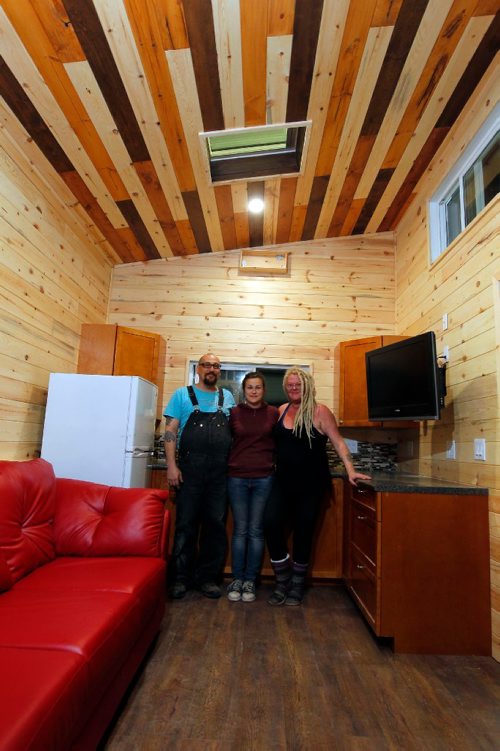 BORIS MINKEVICH / WINNIPEG FREE PRESS
Anita Munn, right,  and her husband, Darrell Manuliak, left, and daughter Bridget Stewart, middle, pose for a photo in one of their mini homes. This one is going to be delivered this Friday to a client who lives near Clear Lake, Manitoba. For story on how the company cant get the city to change its bylaws to allow for mini homes to be build on lots in Winnipeg. Photographed at Mini Homes of Manitoba, Inc. at Unit 13-1557 Brookside Blvd. Oct. 19, 2016