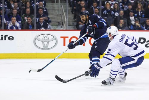 MIKE DEAL / WINNIPEG FREE PRESS

Winnipeg Jets' Dustin Byfuglien (33) fires the puck while Toronto Maple Leafs' Martin Marincin (52) tries to check him during the game at the MTS Centre Wednesday evening. 

161019
Wednesday, October 19, 2016