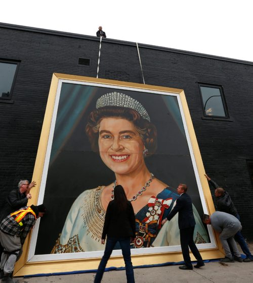 WAYNE GLOWACKI / WINNIPEG FREE PRESS

The huge painting of Queen Elizabeth II from the old Winnipeg Arena is placed against the wall of The Pint on Garry St. Thursday afternoon in the lead up to this weekend's Heritage Classic hockey games. By the Queen's shoulder is Jamie Boychuk one of the owners of the painting.    Queen Kevin Rollason story  Oct. 20 2016