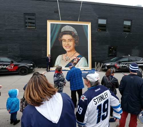 WAYNE GLOWACKI / WINNIPEG FREE PRESS

The huge painting of Queen Elizabeth II from the old Winnipeg Arena was placed against the wall of the The Pint on Garry St. Thursday afternoon in the lead up to this weekend's Heritage Classic hockey games. By the Queen's portrait  is Jamie Boychuk one of the owners of the painting.    Queen Kevin Rollason story  Oct. 20 2016