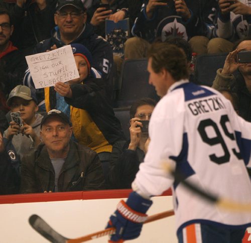 JOE BRYKSA / WINNIPEG FREE PRESS Edmonton Oilers alumni team member Wayne Gretzky, skates by as a fan holds up a sign asking for autographs Friday afternoon  at a team practice in the MTS Centre in Winnipeg  Both the Edmonton Oilers and the Winnipeg Jets alumni teams  hit in the ice to  practice this afternoon in preparation for Saturdays alumni game at the 2016 Heritage Classic -Oct 21, 2016 -(see story)