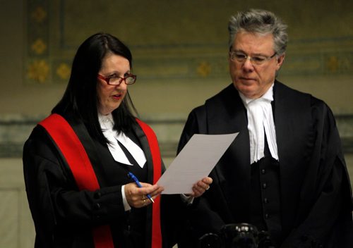 BORIS MINKEVICH / WINNIPEG FREE PRESS
Swearing-in ceremony for The Honourable Chief Judge Margaret Wiebe, left, to the Provincial Court of Manitoba at the Winnipeg Law Courts Complex, 408 York Avenue. Here she does the oath of office and allegiance with The Honourable Mr. Richard J.F. Chartier, right, Chief Justice of Manitoba.  Oct. 21, 2016