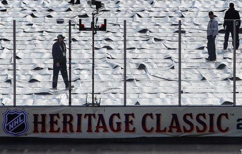 MIKE DEAL / WINNIPEG FREE PRESS
Rink maintenance staff keep an eye on the ice before the NHL game between the Winnipeg Jets and the Edmonton Oilers at Investors Group Field.
161023 - Sunday October 23, 2016