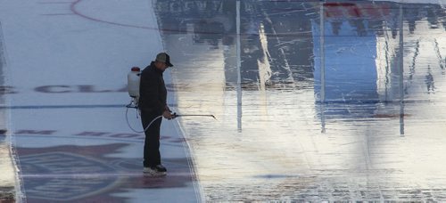 MIKE DEAL / WINNIPEG FREE PRESS
Ice maintenance staff spray water onto the ice prior to the start of the NHL game between the Winnipeg Jets and the Edmonton Oilers at Investors Group Field.
161023 - Sunday October 23, 2016