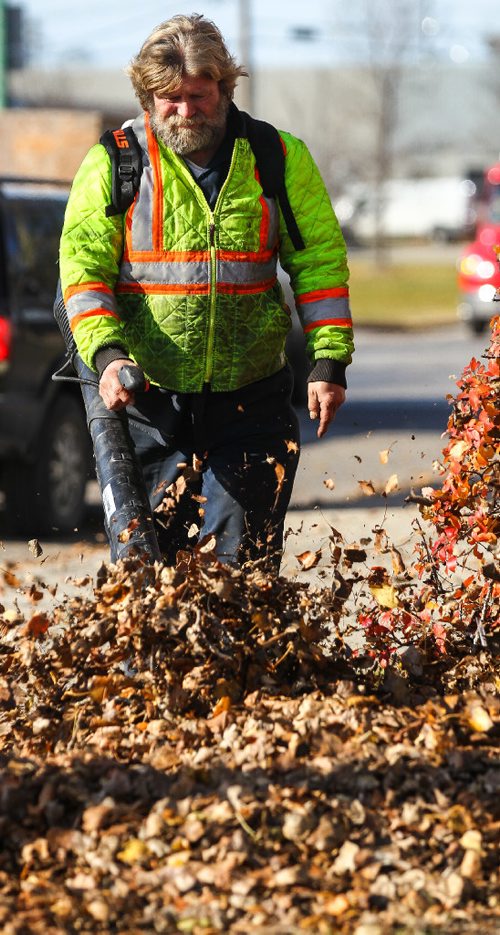 MIKE DEAL / WINNIPEG FREE PRESS
Gerry Fenske tries to get the leaves on his property on Mountain Avenue under control with a leaf blower Tuesday afternoon. 
161025 - Tuesday October 25, 2016