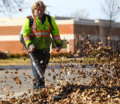 MIKE DEAL / WINNIPEG FREE PRESS
Gerry Fenske tries to get the leaves on his property on Mountain Avenue under control with a leaf blower Tuesday afternoon. 
161025 - Tuesday October 25, 2016