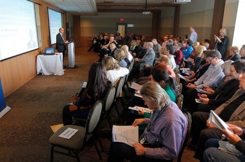 BORIS MINKEVICH / WINNIPEG FREE PRESS
Winnipeg Regional Health Authority (WRHA) President and CEO Milton Sussman, at podium on left,  talks to the group after watching a movie presentation. Meeting was held in the Canad Inns HSC. Oct. 25, 2016