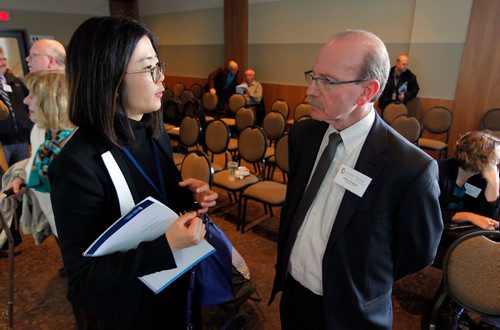 BORIS MINKEVICH / WINNIPEG FREE PRESS
Winnipeg Regional Health Authority Primary Health Statistical Analyst Xue Yao, left,  communicates with Winnipeg Regional Health Authority (WRHA) President and CEO Milton Sussman, right, after the presentation. Meeting was held in the Canad Inns HSC. Oct. 25, 2016